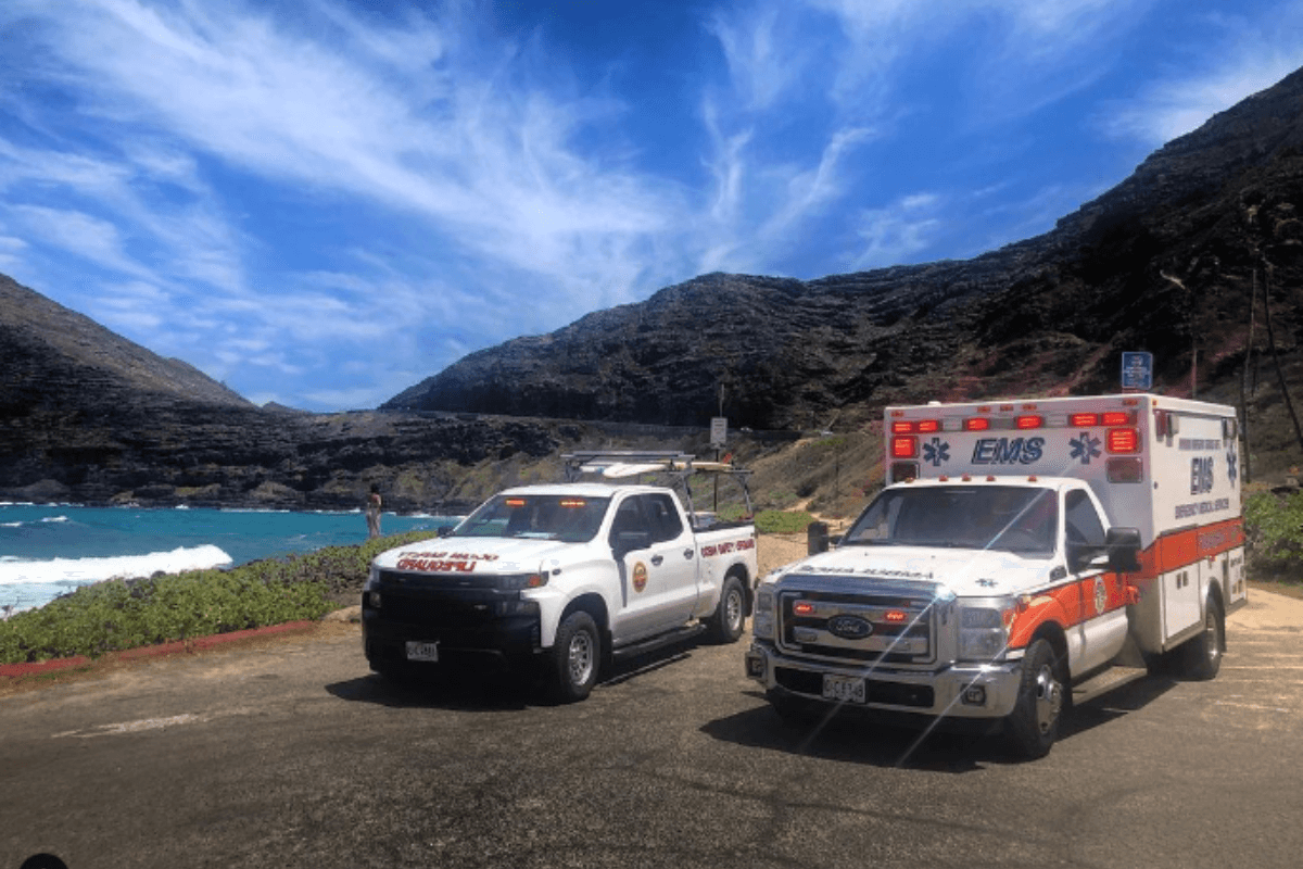 C.O.R.E. Honolulu ambulance and EMS truck in Honolulu at the beach with mountain scenery